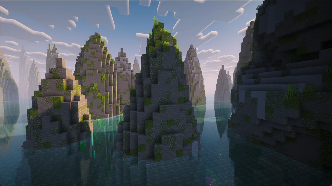 Tall stone rock spire in a lagoon with palm trees, naturally generated near spawn, captured with the Complementary Reimagined shader – own capture from All the Mods 10 8.2